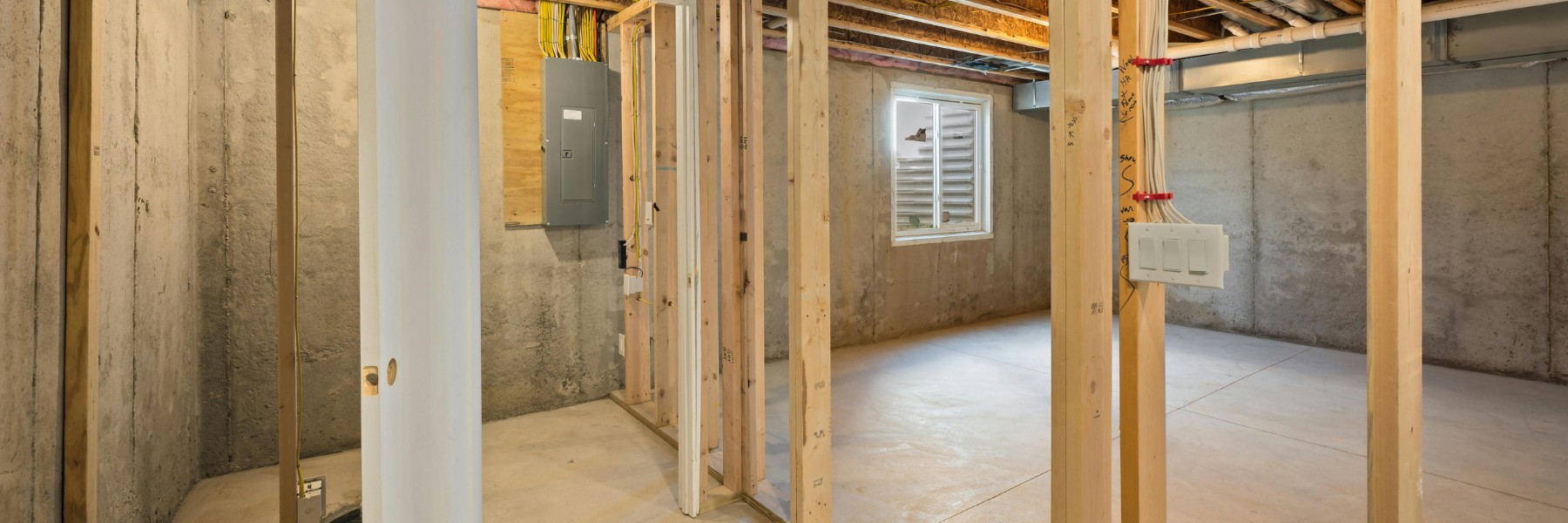 Basement framed with new wood studs during a renovation